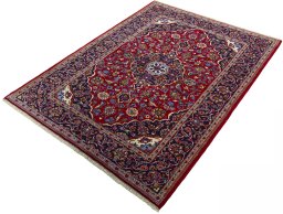 Corner detail of 2000s Kashan rug showing border pattern and Wool pile