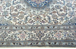 Corner detail of 2000s Nain rug showing border pattern and Wool pile