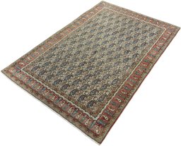 Corner detail of 1950s Ghom rug showing border pattern and Wool pile