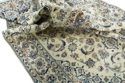 Surface texture of 2000s Nain rug with natural Wool and intricate pattern