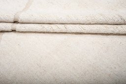Backside of handmade New Morocco rug showing knot structure and weave density