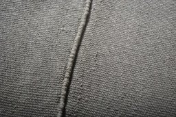 Backside of handmade New Modern Design rug showing knot structure and weave density