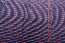 Backside of handmade New Modern Design rug showing knot structure and weave density