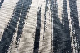 Backside of handmade New Modern Design rug showing knot structure and weave density