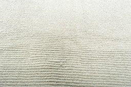 Backside of handmade New Modern Design rug showing knot structure and weave density