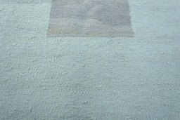 Backside of handmade New Modern Design rug showing knot structure and weave density