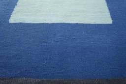 Backside of handmade New Modern Design rug showing knot structure and weave density
