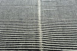 Backside of handmade New Modern Design rug showing knot structure and weave density