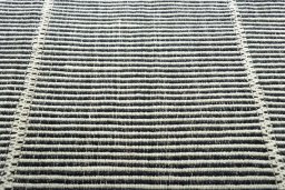 Backside of handmade New Modern Design rug showing knot structure and weave density