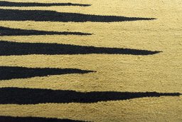 Backside of handmade New Modern Design rug showing knot structure and weave density