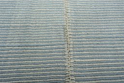 Backside of handmade New Modern Design rug showing knot structure and weave density