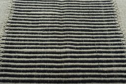 Backside of handmade New Modern Design rug showing knot structure and weave density