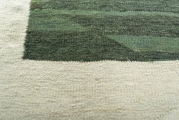 Backside of handmade New Modern Design rug showing knot structure and weave density
