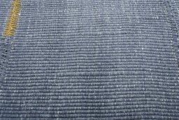 Backside of handmade New Modern Design rug showing knot structure and weave density