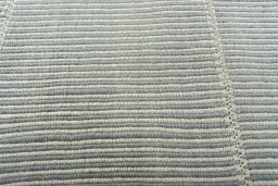 Backside of handmade New Modern Design rug showing knot structure and weave density