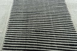 Backside of handmade New Modern Design rug showing knot structure and weave density