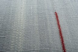 Backside of handmade New Modern Design rug showing knot structure and weave density