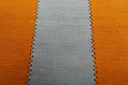 Backside of handmade New Modern Design rug showing knot structure and weave density