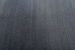 Backside of handmade New Modern Design rug showing knot structure and weave density