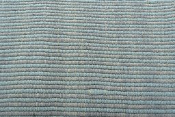 Backside of handmade New Modern Design rug showing knot structure and weave density