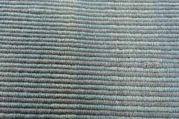 Backside of handmade New Modern Design rug showing knot structure and weave density