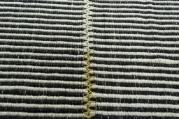 Backside of handmade New Modern Design rug showing knot structure and weave density