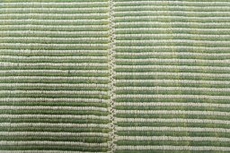 Backside of handmade New Modern Design rug showing knot structure and weave density