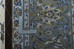 Backside of handmade 2000s Kashan rug showing knot structure and weave density