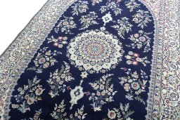 Backside of handmade 2000s Nain rug showing knot structure and weave density