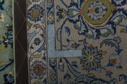 Backside of handmade 2000s Kashan rug showing knot structure and weave density