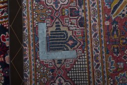 Backside of handmade 2000s Kashan rug showing knot structure and weave density