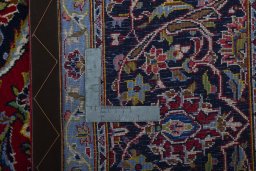 Backside of handmade New Kashan rug showing knot structure and weave density