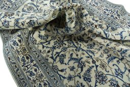 Surface texture of 2000s Nain rug with natural Wool and intricate pattern