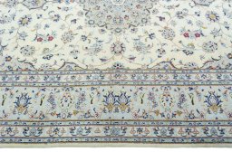 Corner detail of 2000s Kashan rug showing border pattern and Wool pile