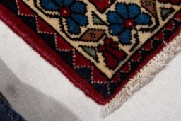 Backside of handmade New Abadeh rug showing knot structure and weave density