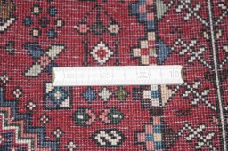 Backside of handmade New Abadeh rug showing knot structure and weave density
