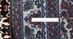 Surface texture of 1950s Abadeh rug with natural Wool and intricate pattern
