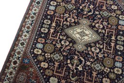 Backside of handmade New Abadeh rug showing knot structure and weave density