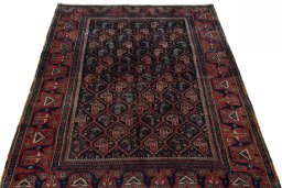 Surface texture of 1930s Afshar rug with natural Wool and intricate pattern