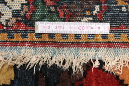 Backside of handmade 1900s Bakhtiar rug showing knot structure and weave density