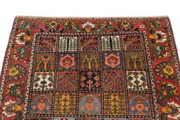 Surface texture of 1920s Bakhtiar rug with natural Wool and intricate pattern