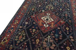 Backside of handmade 1930s Bakhtiar rug showing knot structure and weave density