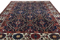 Surface texture of 1930s Bakhtiar rug with natural Wool and intricate pattern