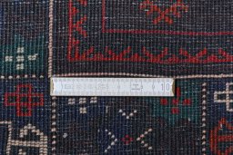 Corner detail of 2000s Baloch rug showing border pattern and Wool pile