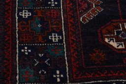 Backside of handmade 2000s Baloch rug showing knot structure and weave density