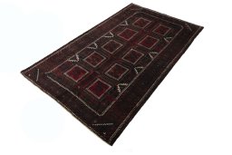 Corner detail of 2000s Baloch rug showing border pattern and Wool pile