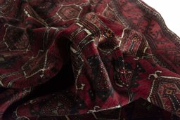 Corner detail of 2000s Baloch rug showing border pattern and Wool pile