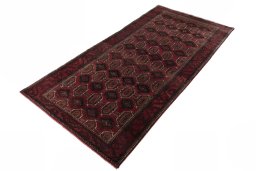 Corner detail of 2000s Baloch rug showing border pattern and Wool pile