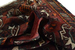Corner detail of 2000s Baloch rug showing border pattern and Wool pile