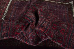 Corner detail of 2000s Baloch rug showing border pattern and Wool pile